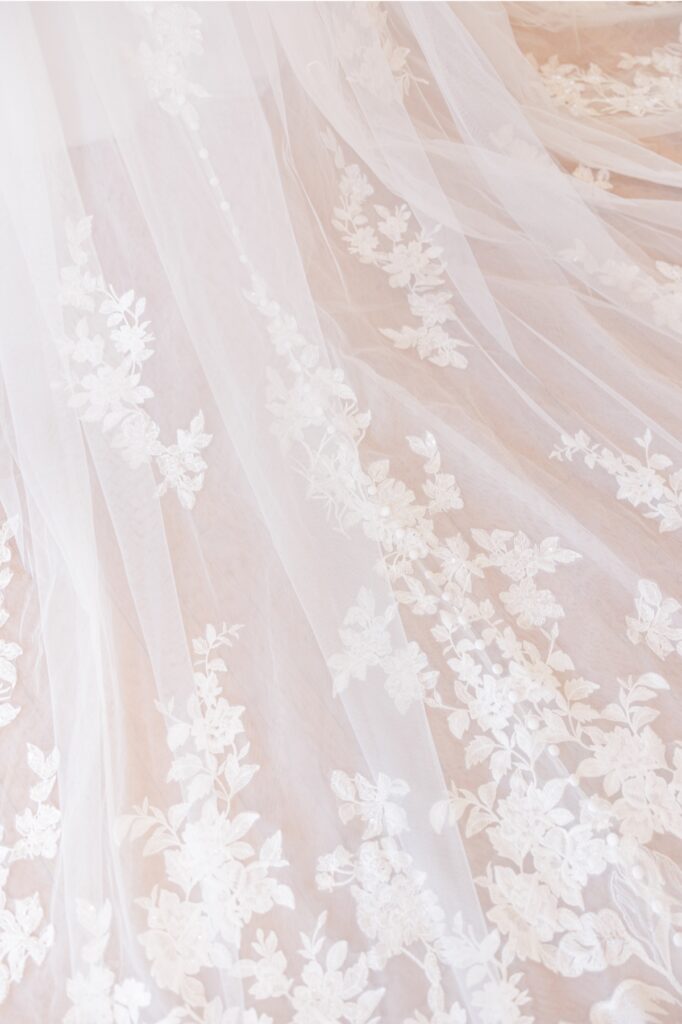 Close-up of floral lace appliques on the bride’s Salem Country Club wedding gown.