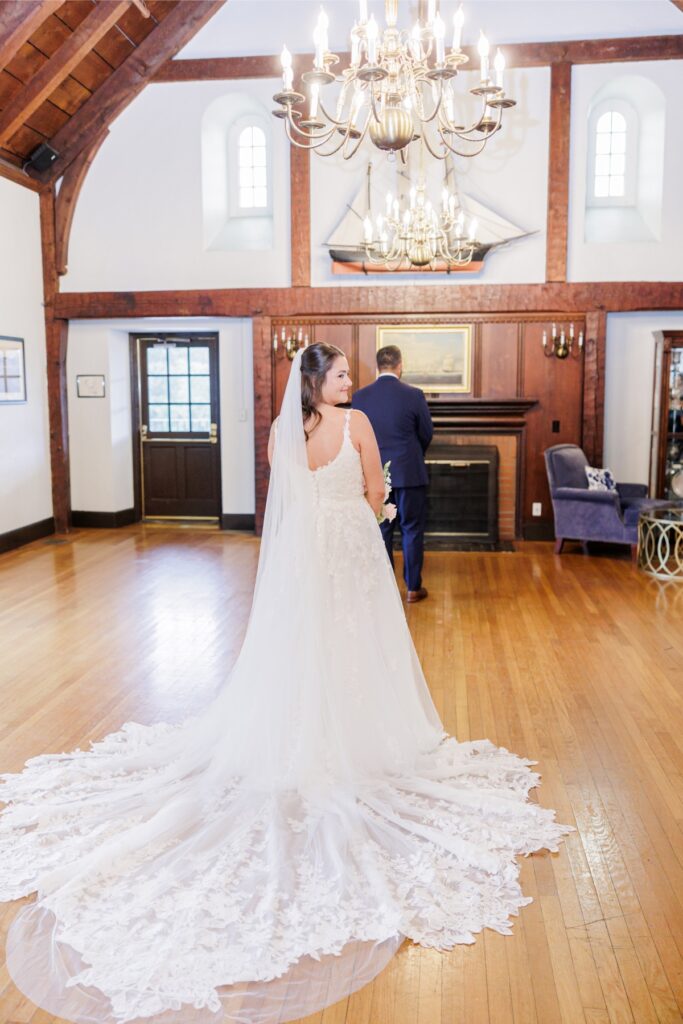The bride approaching the groom for their indoor first look at their Salem Country Club wedding.