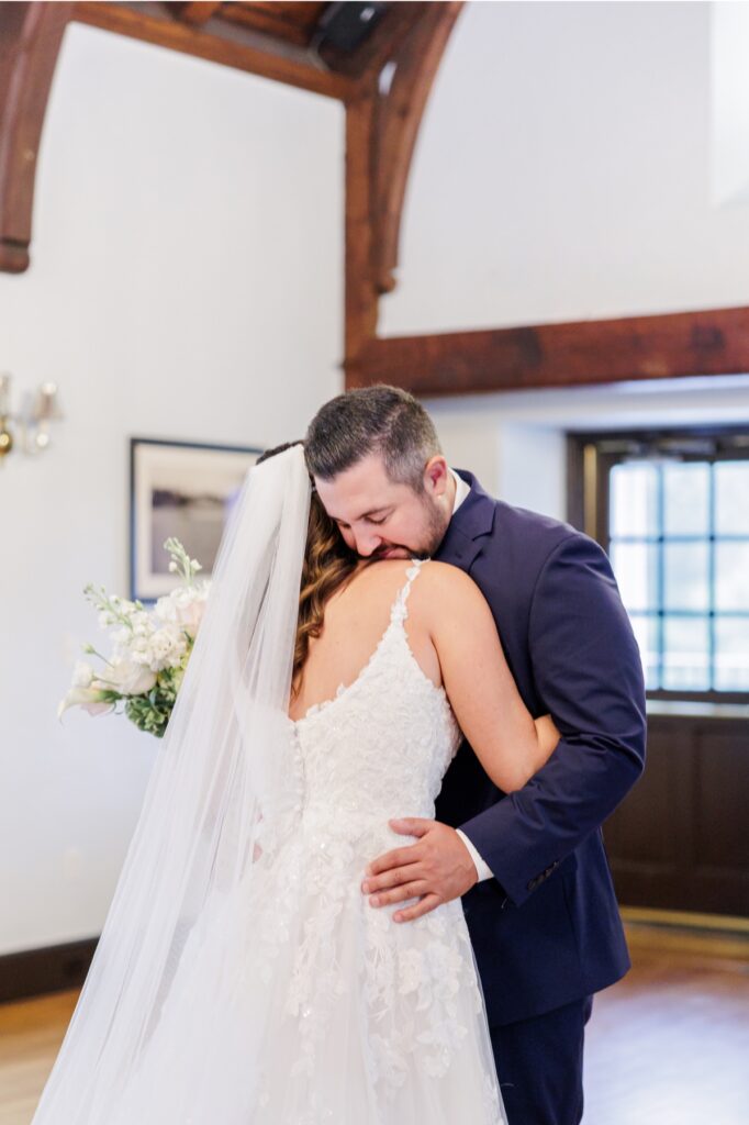 The bride and groom embracing after their emotional Salem Country Club wedding first look.