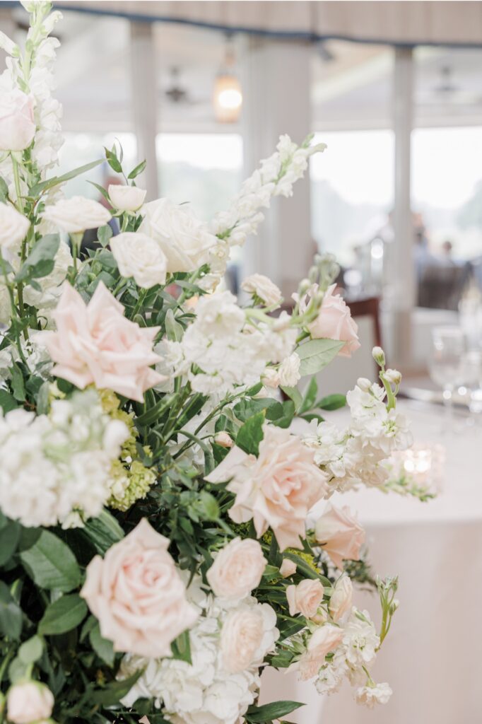 Airy blush roses and white flowers decorating the Salem Country Club wedding reception.