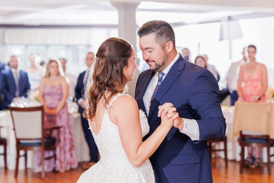 The bride and groom holding hands and looking at each other during their Salem Country Club wedding first dance.